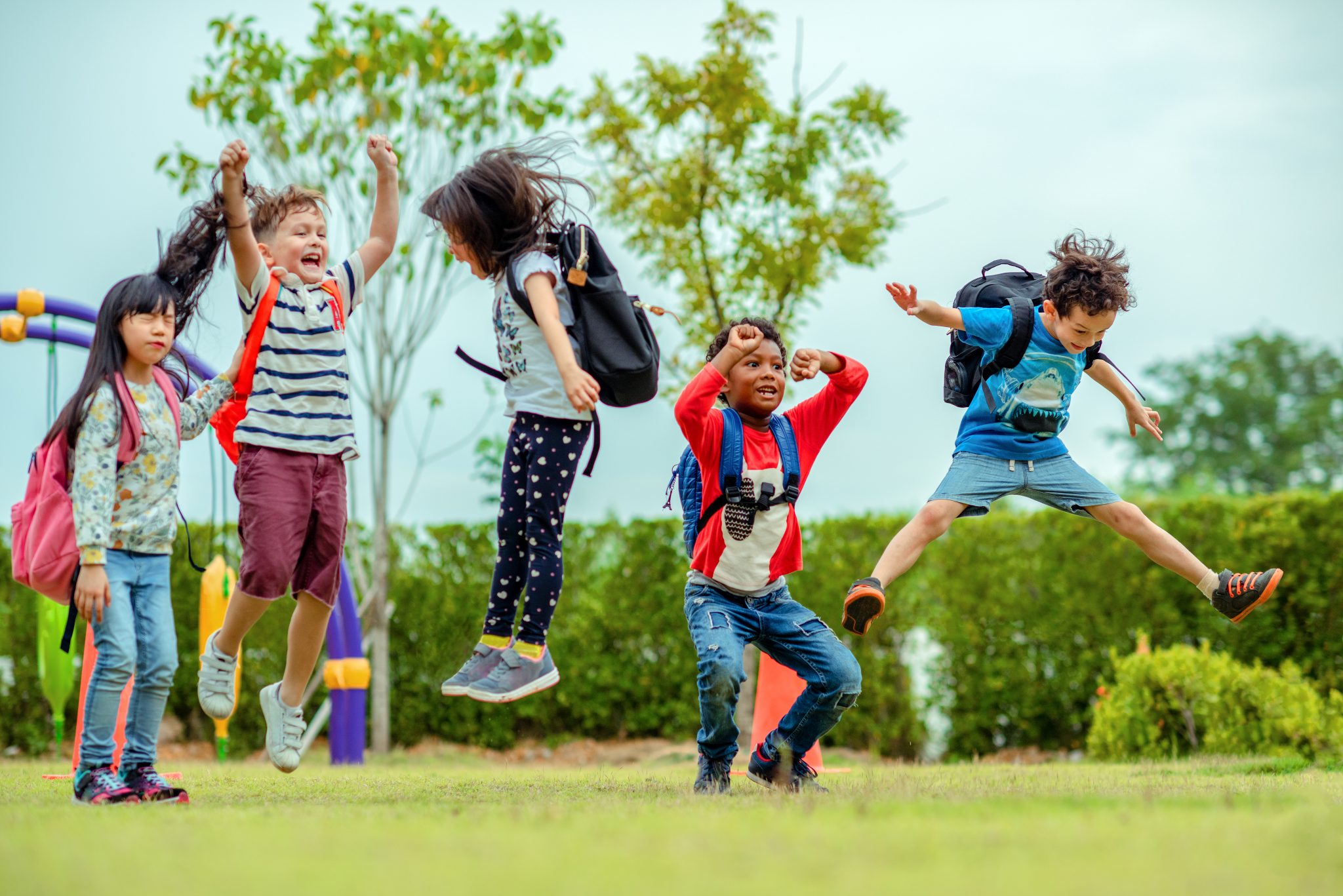 Kids Jumping Outside With Backpacks Mk Act